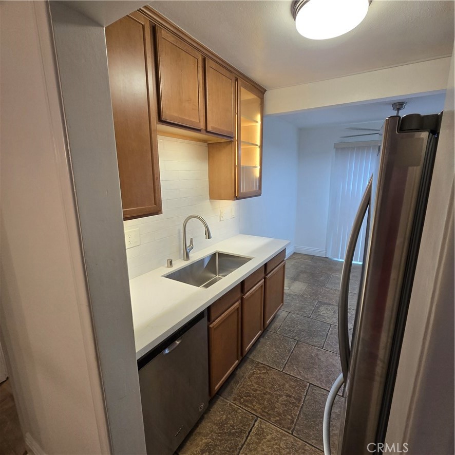 1440 West Lambert Road, Unit 233 La Habra, CA 90631 - Photo 12 of 26 a kitchen with stainless steel appliances granite countertop a sink stove and refrigerator