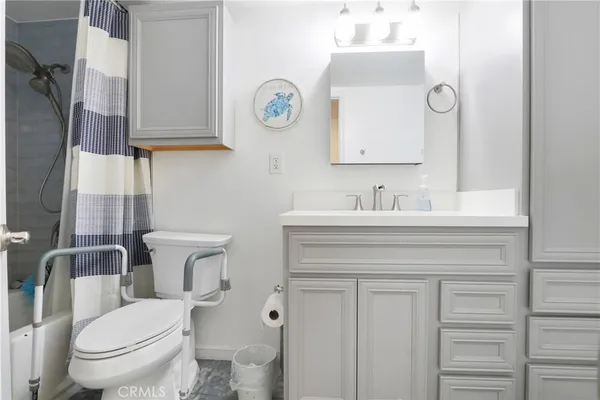a white toilet sitting next to a bath tub