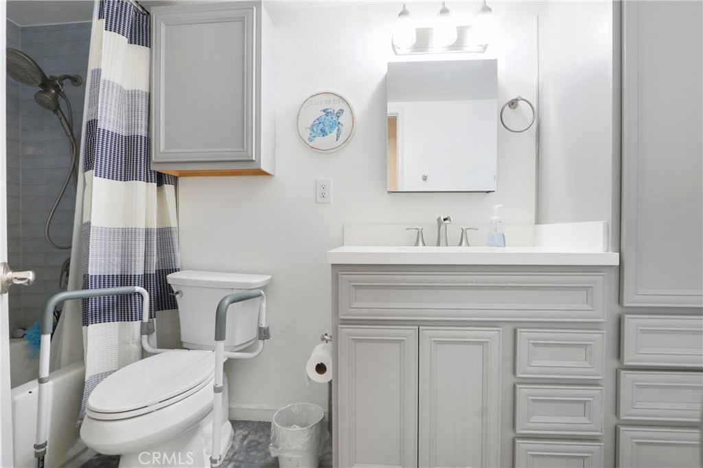 1440 West Lambert Road, Unit 233 La Habra, CA 90631 - Photo 19 of 26 a bathroom with a toilet sink vanity and mirror