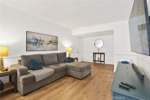 a living room with furniture and a wooden floor
