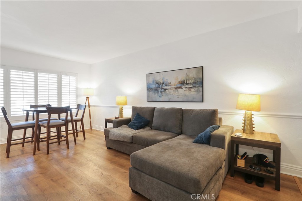 1440 West Lambert Road, Unit 233 La Habra, CA 90631 - Photo 6 of 26 a living room with furniture and a wooden floor