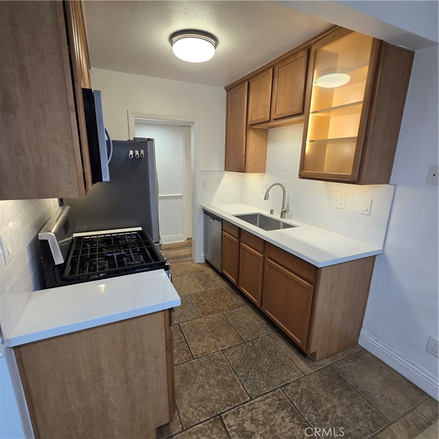 1440 West Lambert Road, Unit 233 La Habra, CA 90631 - Photo 9 of 26 a kitchen with stainless steel appliances granite countertop a sink stove and refrigerator