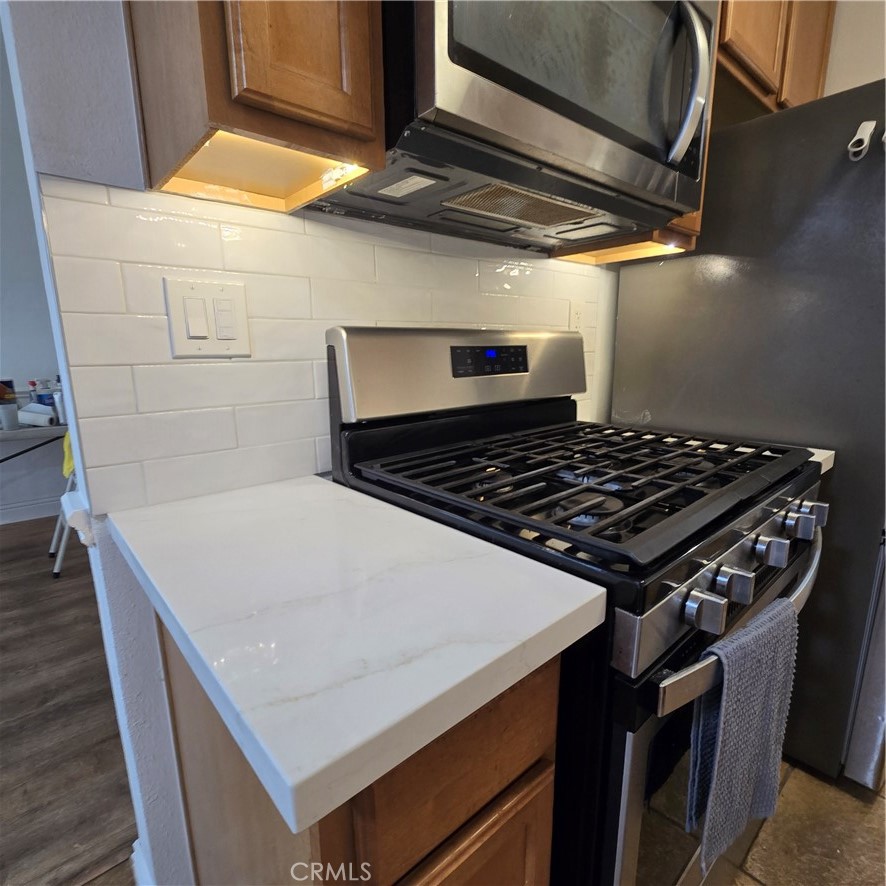 1440 West Lambert Road, Unit 233 La Habra, CA 90631 - Photo 10 of 26 a stove top oven sitting inside of a kitchen