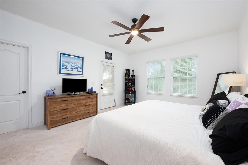 12305 Via Derna Place Windermere, FL 34786 - Photo 12 of 24 a bedroom with a bed and a flat screen tv