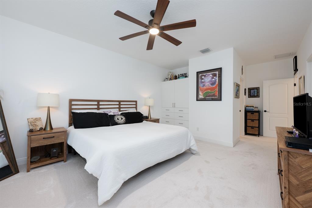 12305 Via Derna Place Windermere, FL 34786 - Photo 13 of 24 a bedroom with a bed and a tv on the dresser