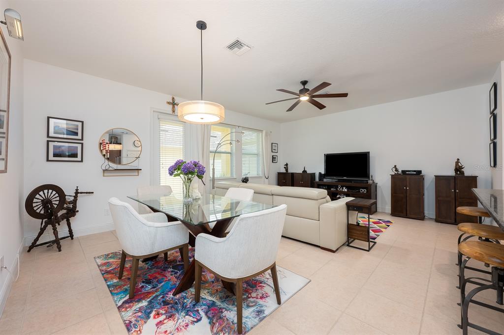12305 Via Derna Place Windermere, FL 34786 - Photo 9 of 24 a living room with furniture a chandelier and a flat screen tv