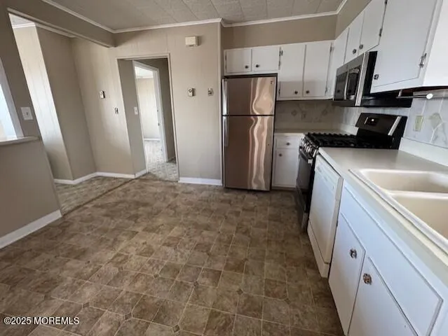 a kitchen with a refrigerator a stove a sink dishwasher and wooden cabinets