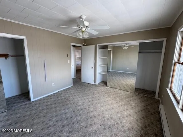 an empty room with closet and windows