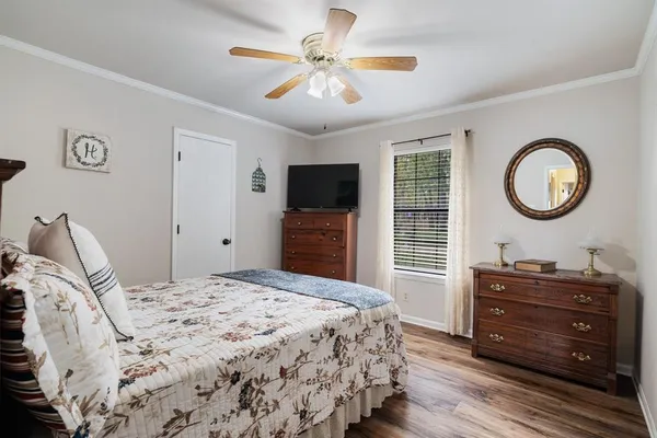 a bedroom with a bed and a chandelier