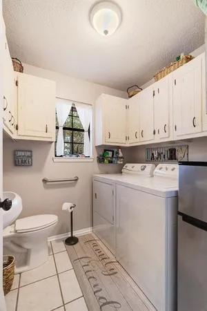 a kitchen with a sink a stove cabinets and a window