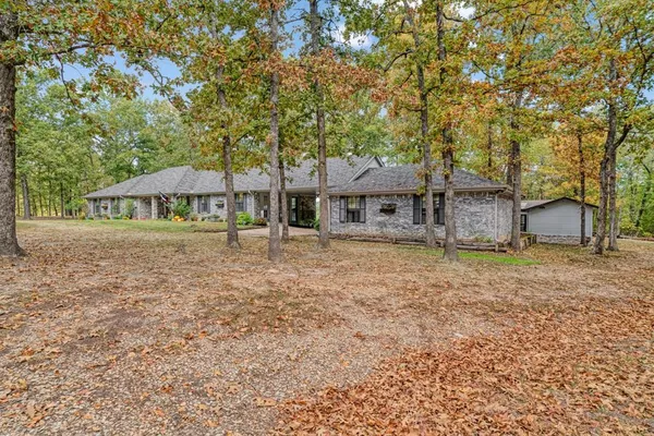 a view of a house with a yard and sitting area
