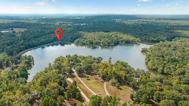 an aerial view of a houses with a lake view