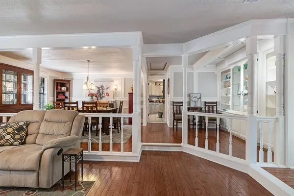 a living room with furniture and a wooden floor