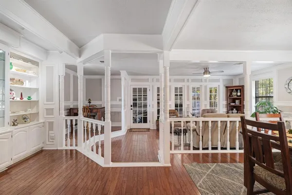 a view of a kitchen with furniture and wooden floor