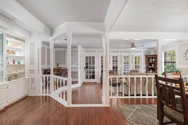 a view of a kitchen with furniture and wooden floor