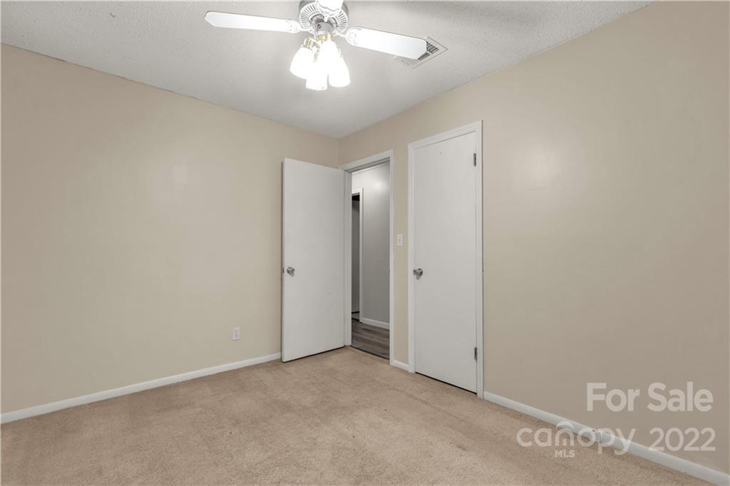 1909 John Everall Road Lancaster, SC 29720 - Photo 16 of 32 an empty room with a chandelier fan and a bathroom
