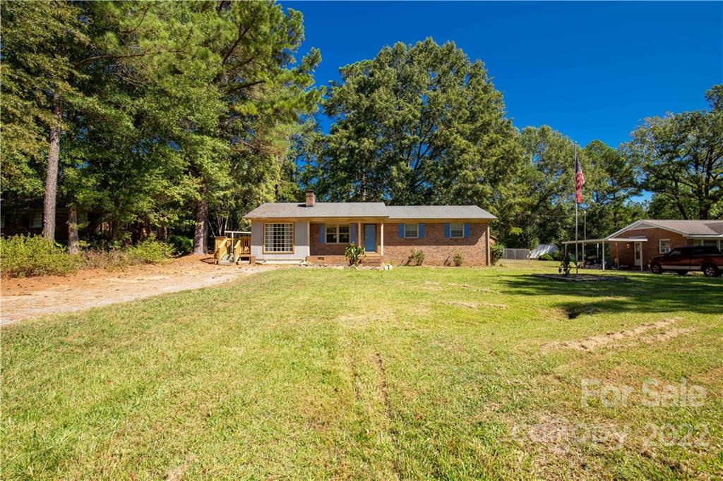 1909 John Everall Road Lancaster, SC 29720 - Photo 3 of 32 a front view of house with yard and trees in the background