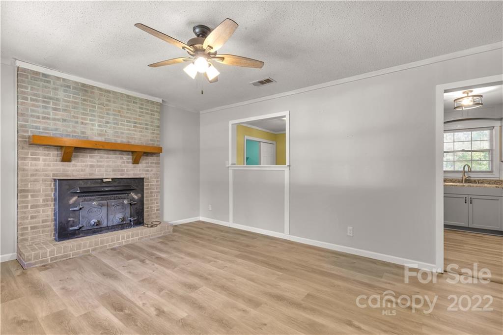 1909 John Everall Road Lancaster, SC 29720 - Photo 6 of 32 a view of an empty room with a fireplace and a window