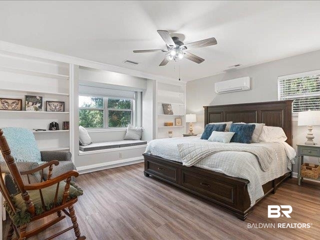 4650 Wiggins Lane Wilmer, AL 36587 - Photo 15 of 66 Bedroom with wood finished floors, a ceiling fan, and a wall mounted air conditioner