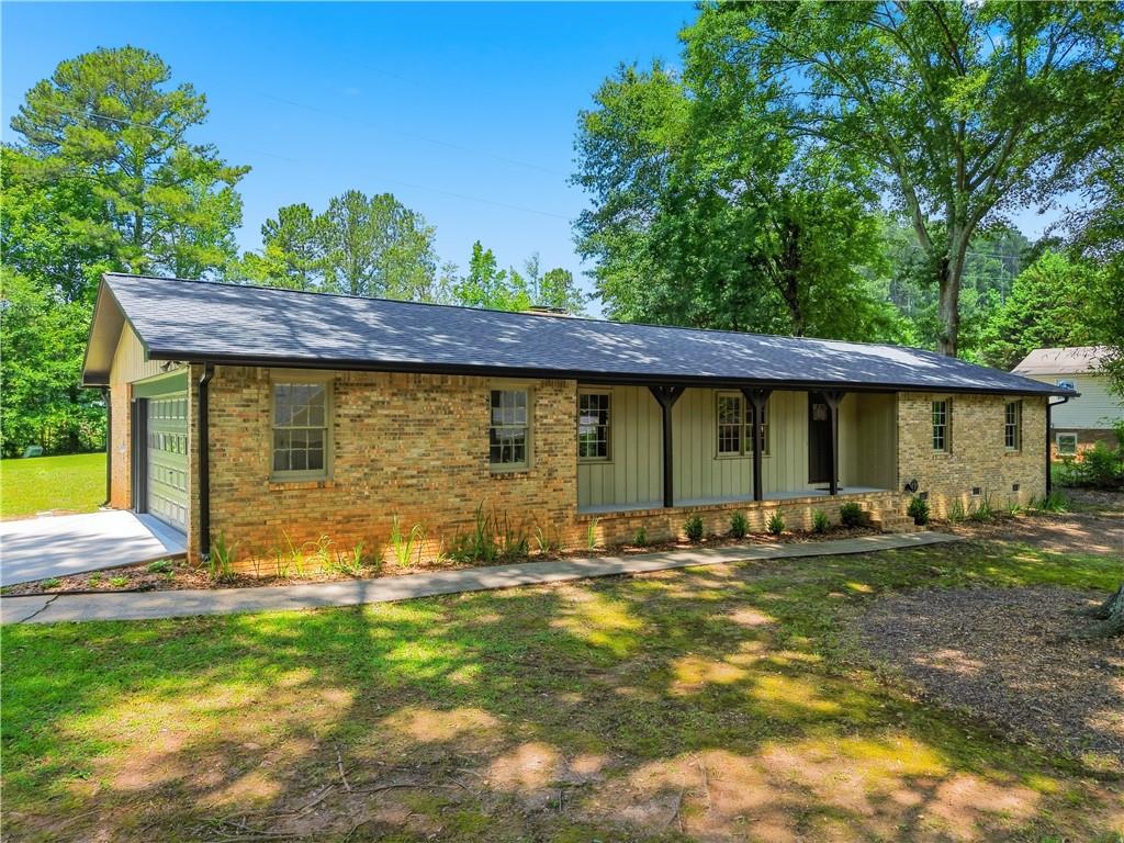 125 Childers Road Canton, GA 30115 - Photo 3 of 48 a backyard of a house with table and chairs