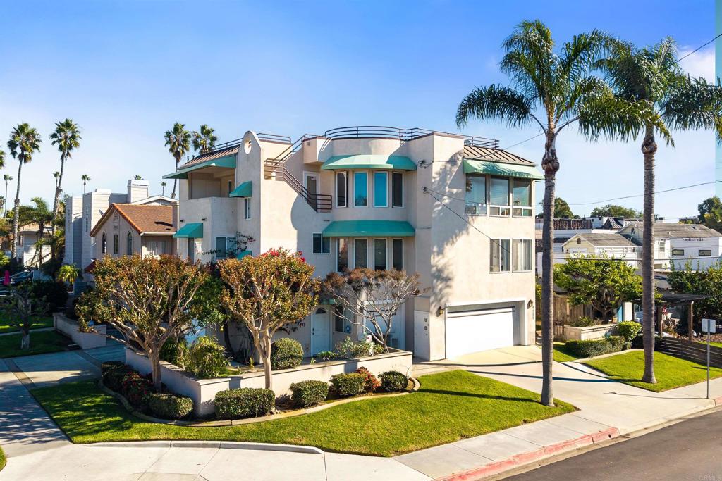 a front view of multiple houses with yard