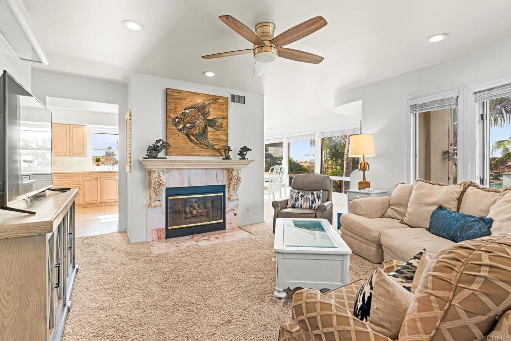 1105 Reed Avenue San Diego, CA 92109 - Photo 11 of 34 a living room with furniture a fireplace and a large window