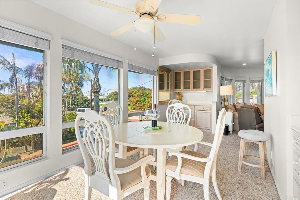 1105 Reed Avenue San Diego, CA 92109 - Photo 14 of 34 a dining room with furniture a chandelier and wooden floor