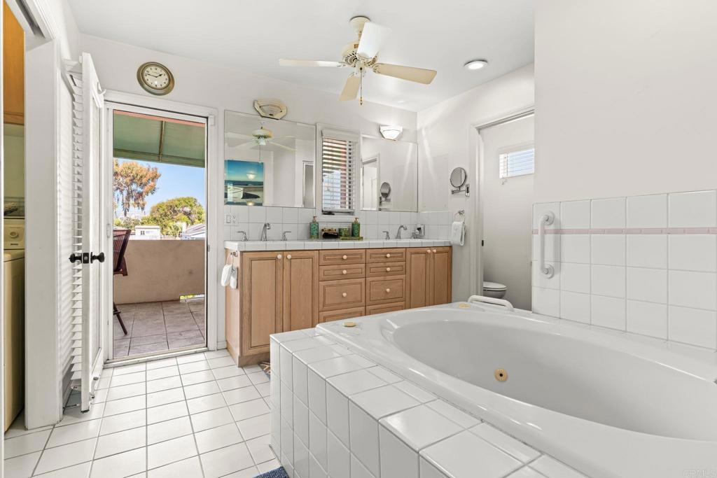 1105 Reed Avenue San Diego, CA 92109 - Photo 21 of 34 a spacious bathroom with a tub sink shower and mirror