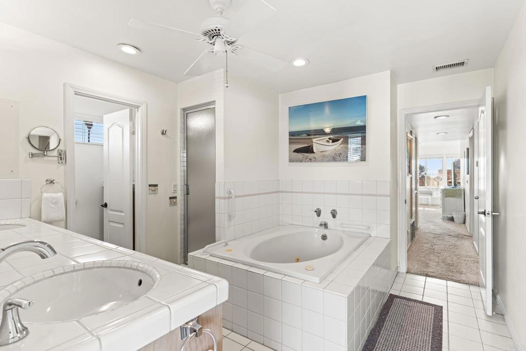 1105 Reed Avenue San Diego, CA 92109 - Photo 23 of 34 a bathroom with a tub sink and mirror