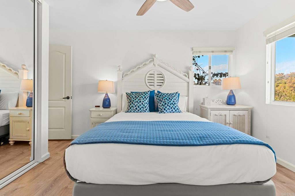 1105 Reed Avenue San Diego, CA 92109 - Photo 5 of 34 a bedroom with a bed and wooden floor