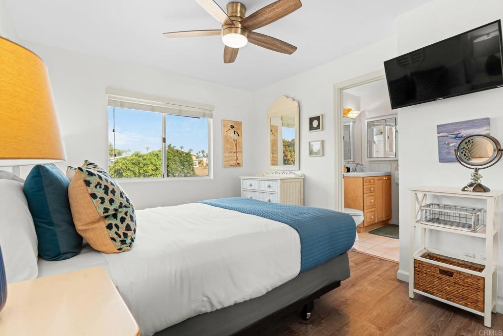 1105 Reed Avenue San Diego, CA 92109 - Photo 6 of 34 a bedroom with a bed a window and a flat screen tv