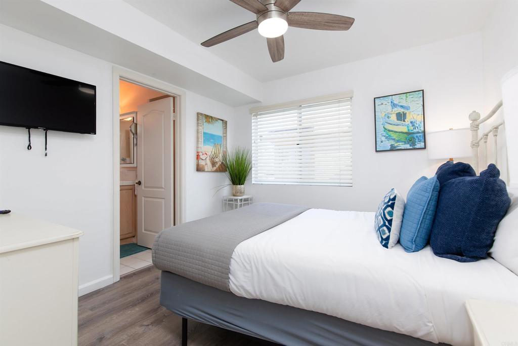 1105 Reed Avenue San Diego, CA 92109 - Photo 9 of 34 a bedroom with a bed window and a flat screen tv