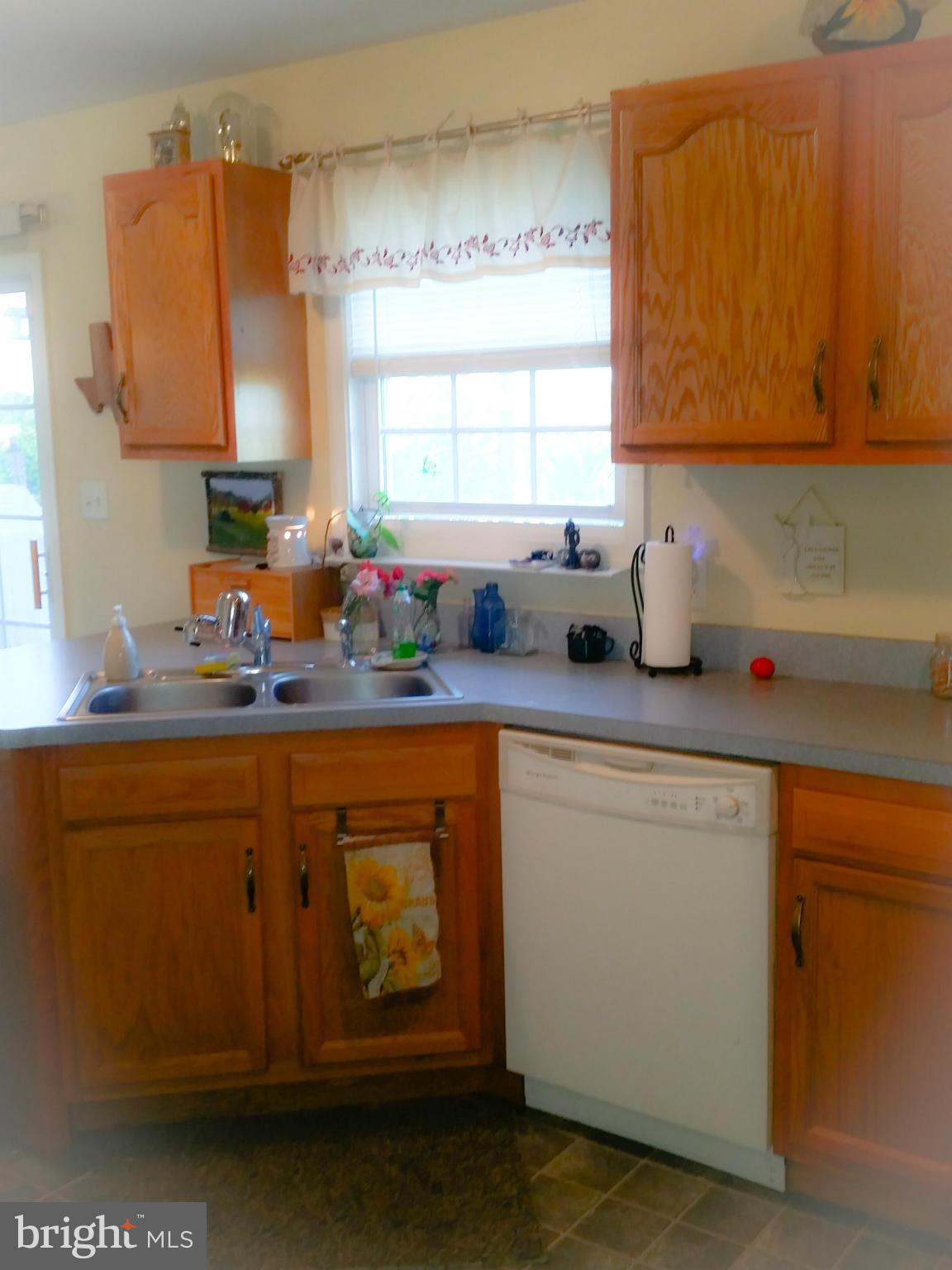 426 Thumper Drive Ranson, WV 25438 - Photo 7 of 30 a kitchen with stainless steel appliances granite countertop a sink window and cabinets