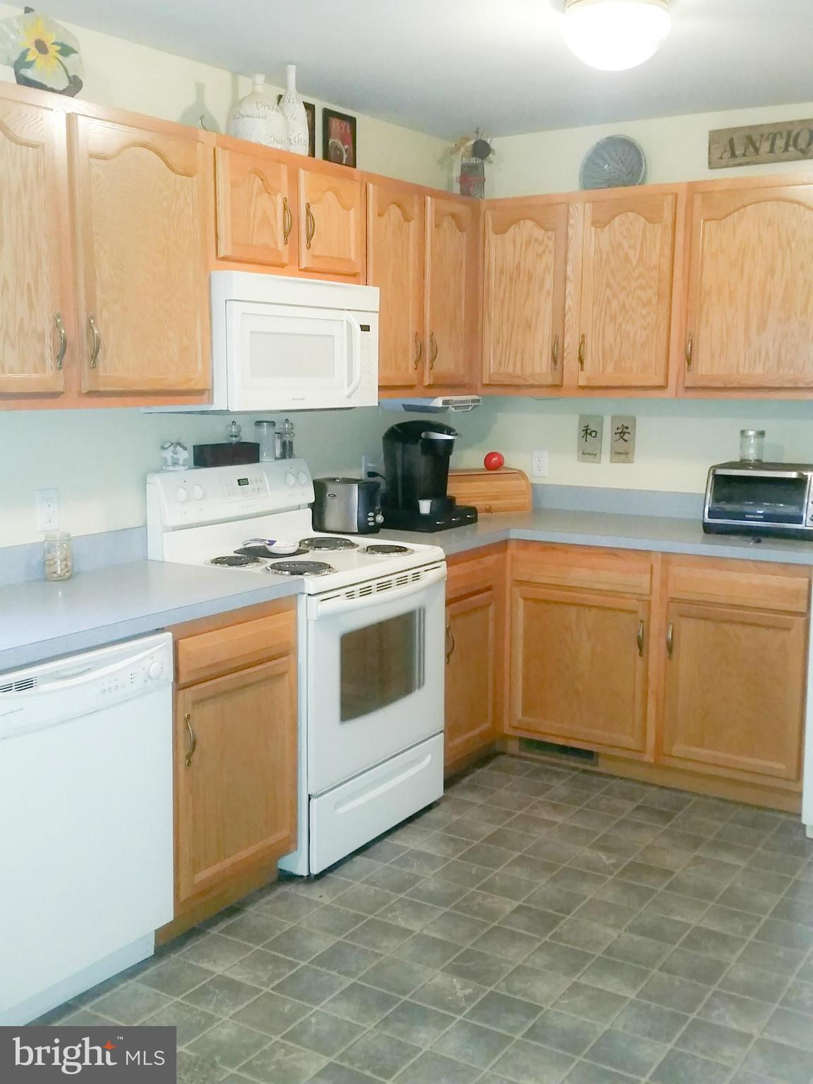 426 Thumper Drive Ranson, WV 25438 - Photo 8 of 30 a kitchen with a white stove top oven sink and cabinets