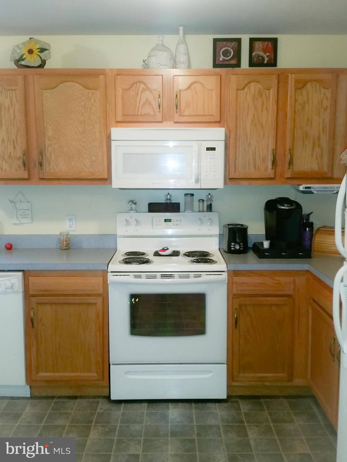 426 Thumper Drive Ranson, WV 25438 - Photo 9 of 30 a white stove top oven sitting inside of a kitchen