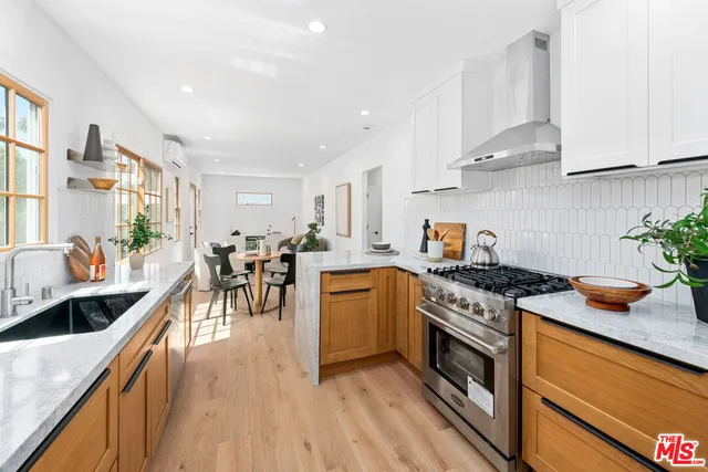a kitchen with stove and cabinets