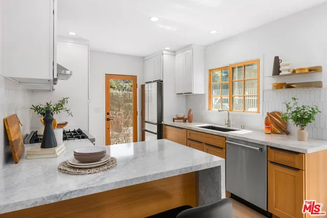 a stove top oven sitting inside of a kitchen