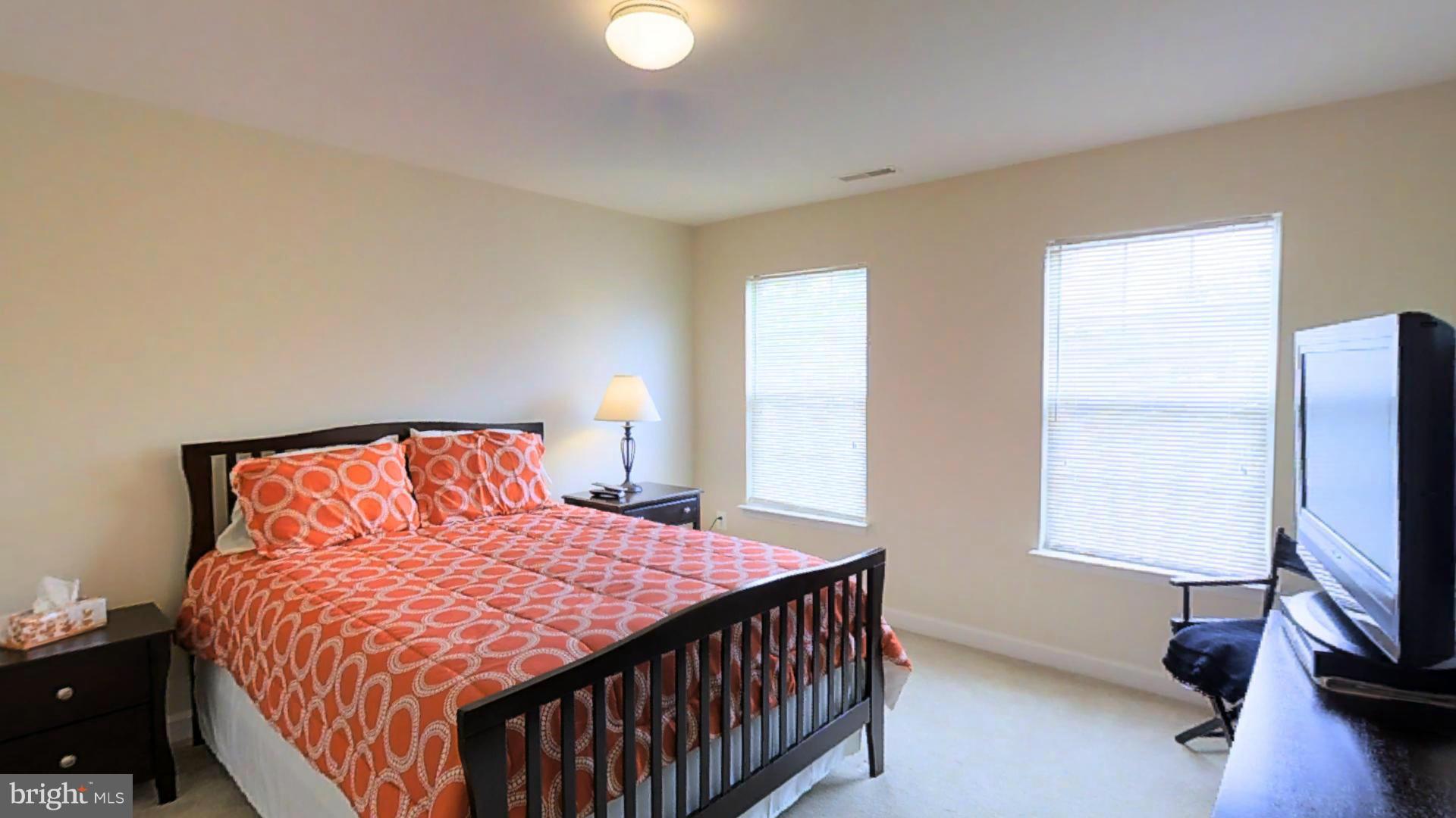 1711 Canal Clipper Court Point of Rocks, MD 21777 - Photo 14 of 30 a bedroom with a bed a window and a flat screen tv