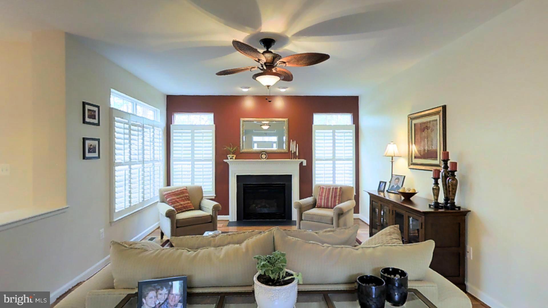 1711 Canal Clipper Court Point of Rocks, MD 21777 - Photo 6 of 30 a living room with furniture a fireplace and a chandelier