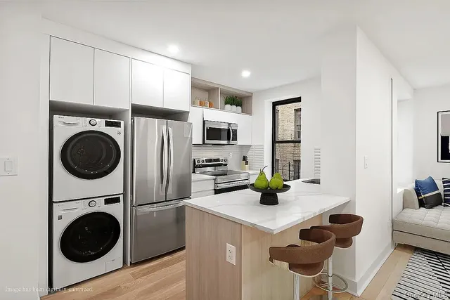 a kitchen with sink cabinets and stainless steel appliances