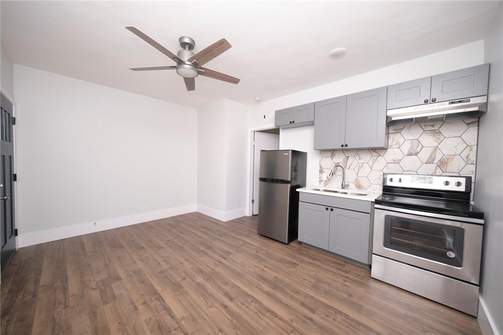 206 West 45th Street Austin, TX 78751 - Photo 3 of 6 a kitchen with a stove sink and refrigerator