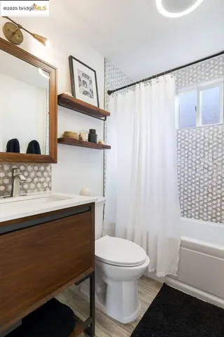 a bathroom with a toilet a sink and a mirror