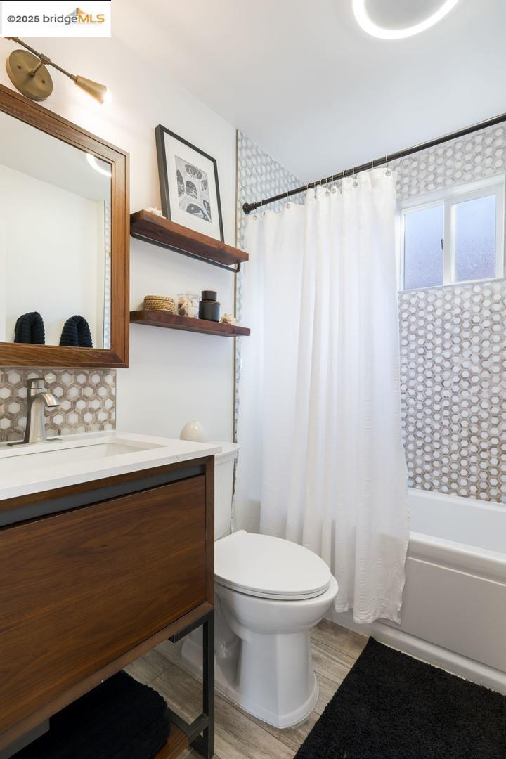 2829 California Street Berkeley, CA 94703 - Photo 12 of 20 a bathroom with a toilet a sink and a mirror
