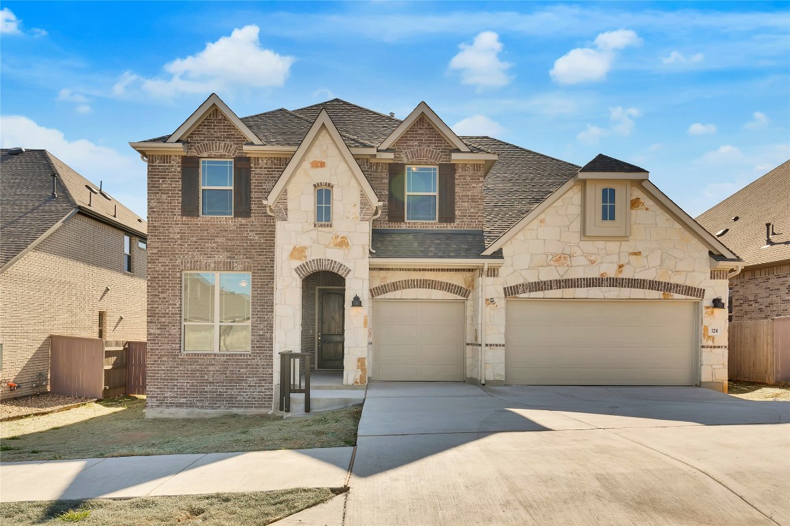 a view of a white house next to a yard