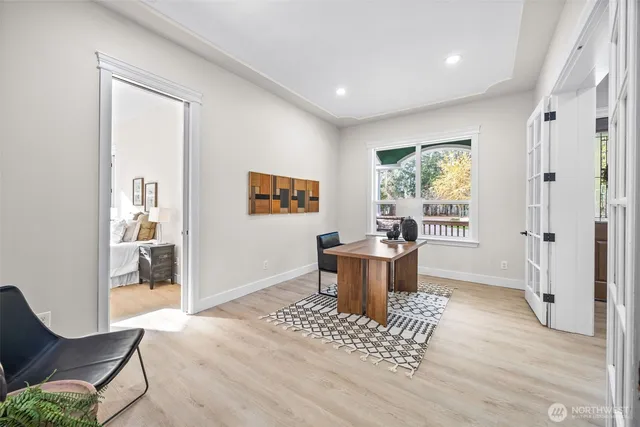 a view of a livingroom with a chair and wooden floor