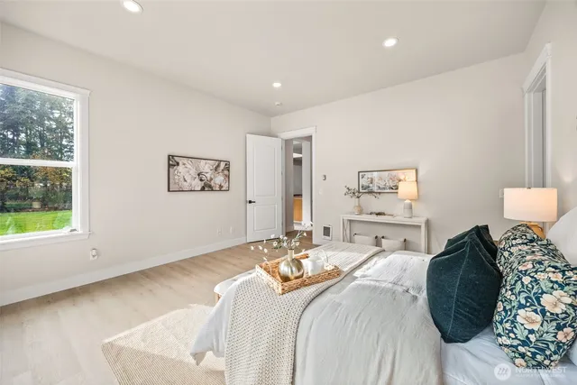 a bedroom with a large bed and a window