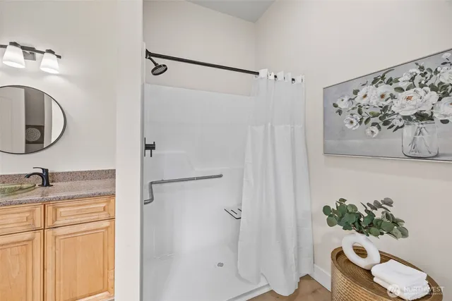 a bathroom with a granite countertop sink toilet and shower