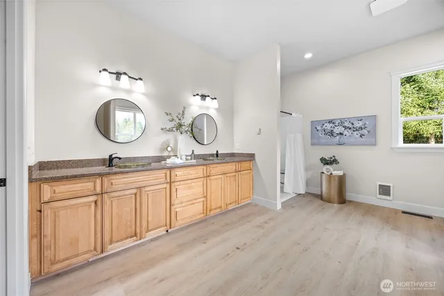 a spacious bathroom with a double vanity sink and a mirror