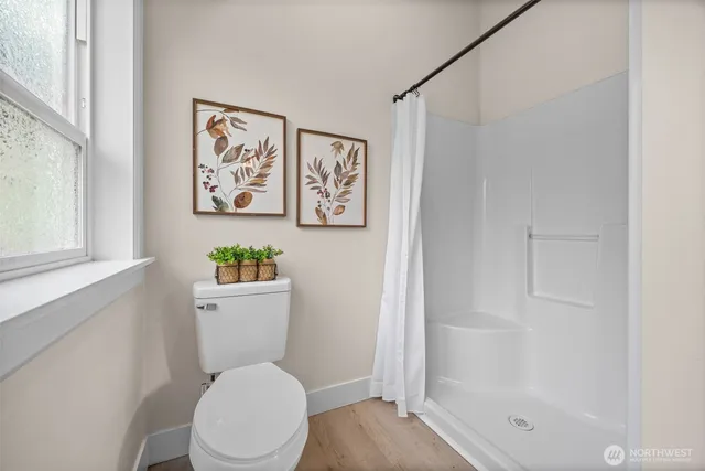 a white toilet sitting next to a bathroom sink and tub