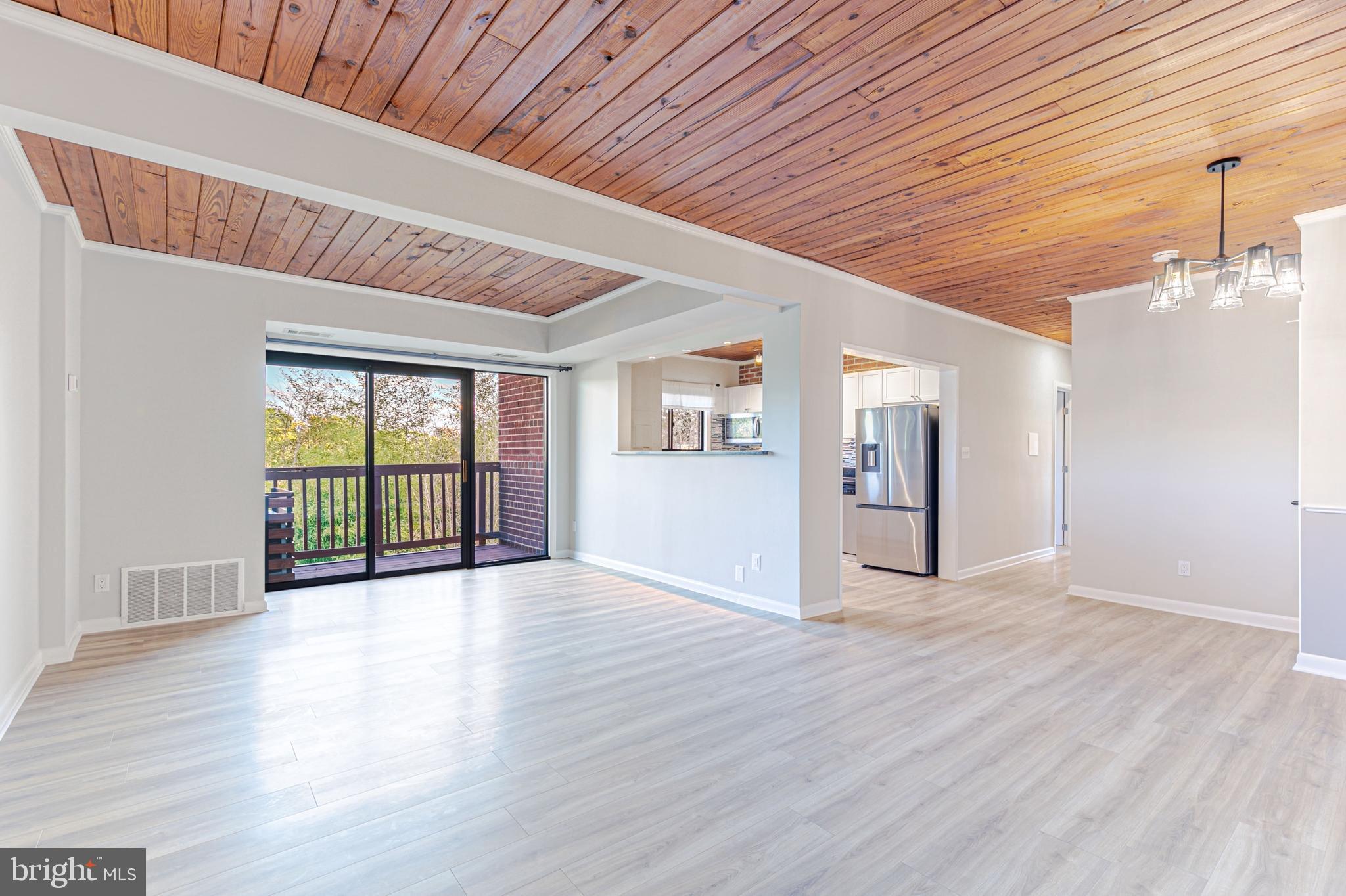 53 Skyhill Road, Unit 303 Alexandria, VA 22314 - Photo 1 of 22 a view of an empty room with wooden floor and a window